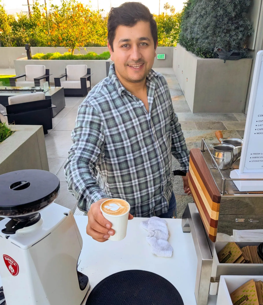 A barista pouring serving art latte at Los Angeles event party.